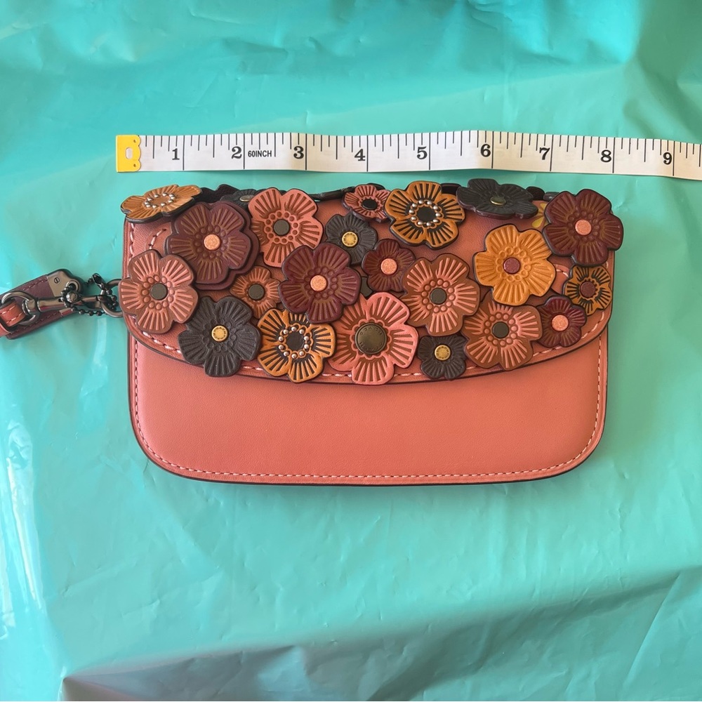 NWOT pink coach wristlet with flower embellishments genuine leather
